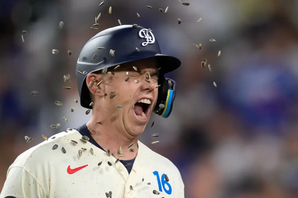 Dodgers’ Will Smith has seeds thrown at him after hitting...