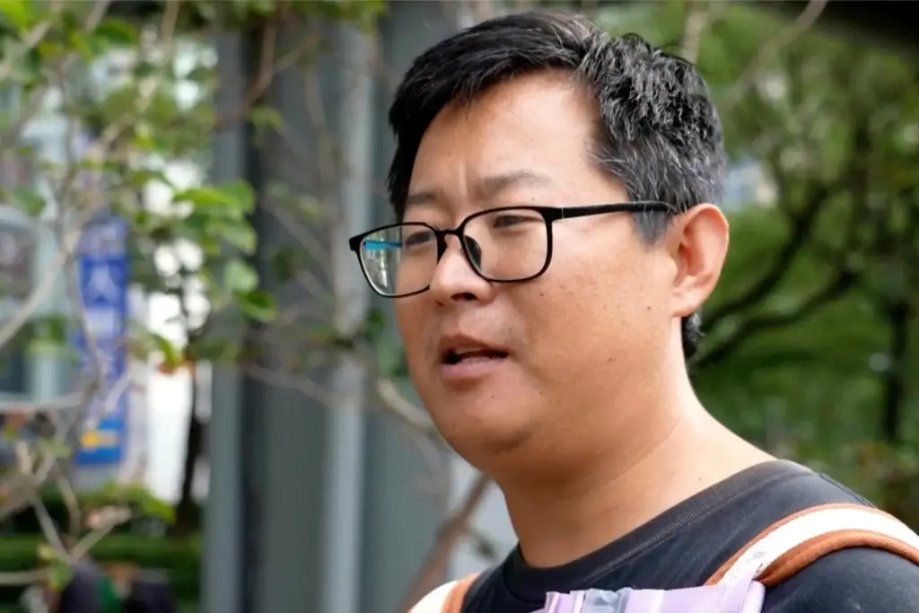 Beijing resident Shen Zuohang speaks on the streets of Beijing.