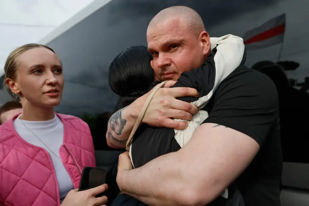 Dzmitryi Halavach, one of the released Belarusian prisoners, embraces his...