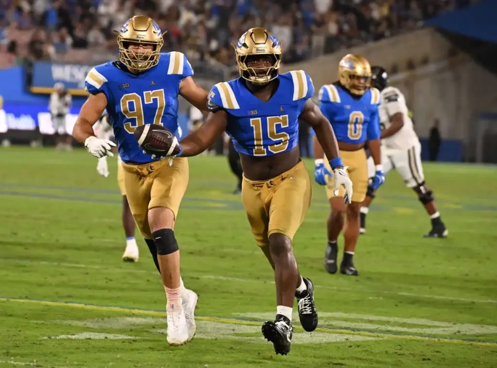 Defensive lineman Sahir West (15) of the UCLA Bruins recovers...