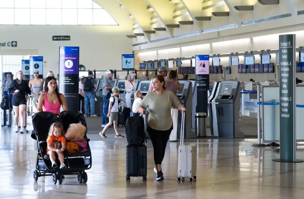 Travelers head to the security checkpoint at John Wayne Airport...