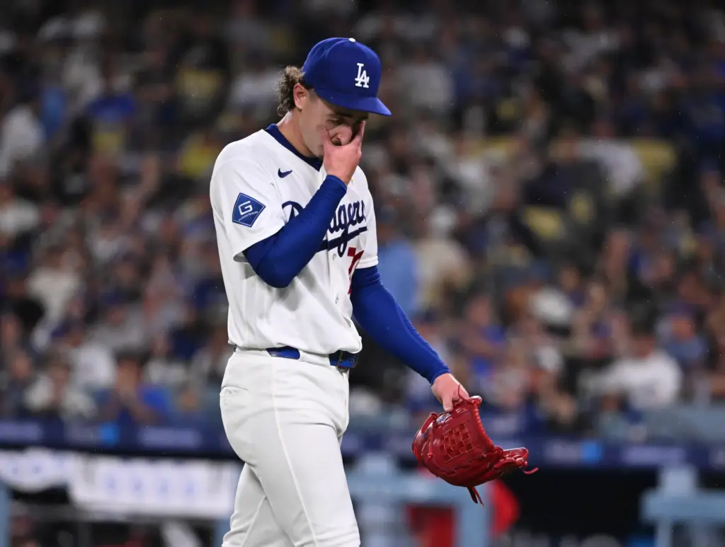 Dodgers starting pitcher Justin Wrobleski wipes his face after being...