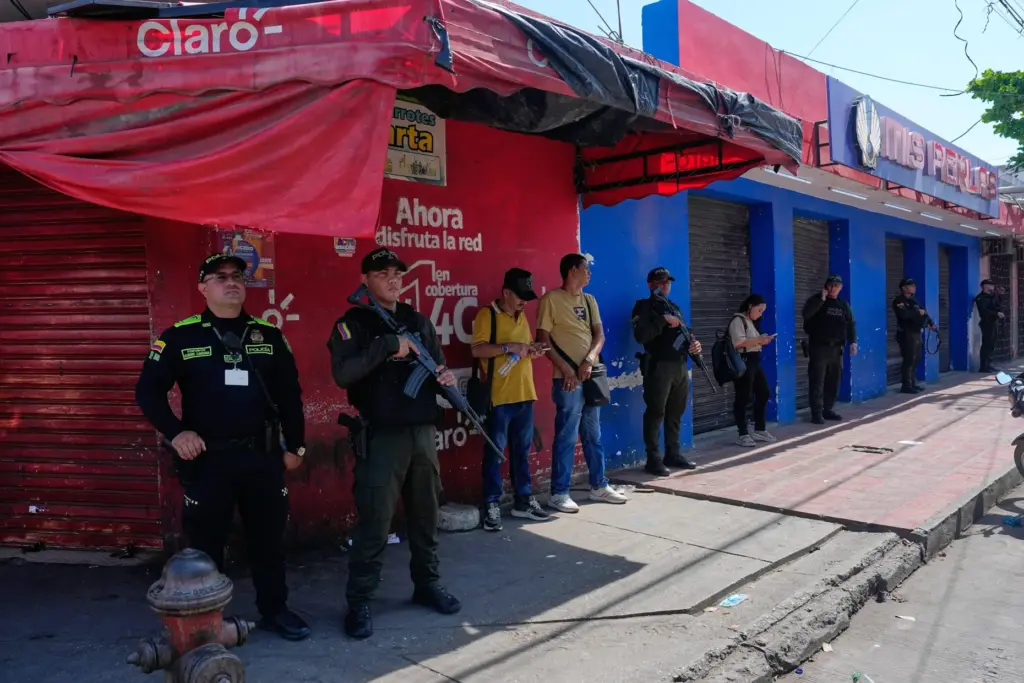 Police stand guard at a market where shop owners did...