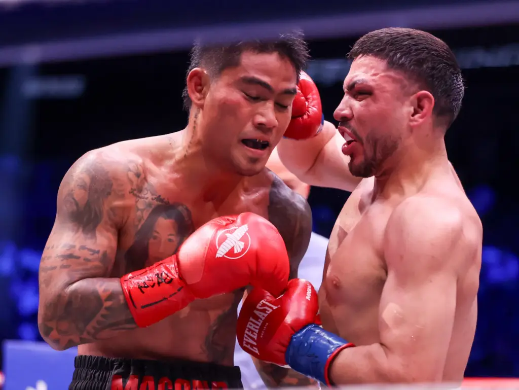 Andres Cortes, right, punches Mark Magsayo in their lightweight fight...