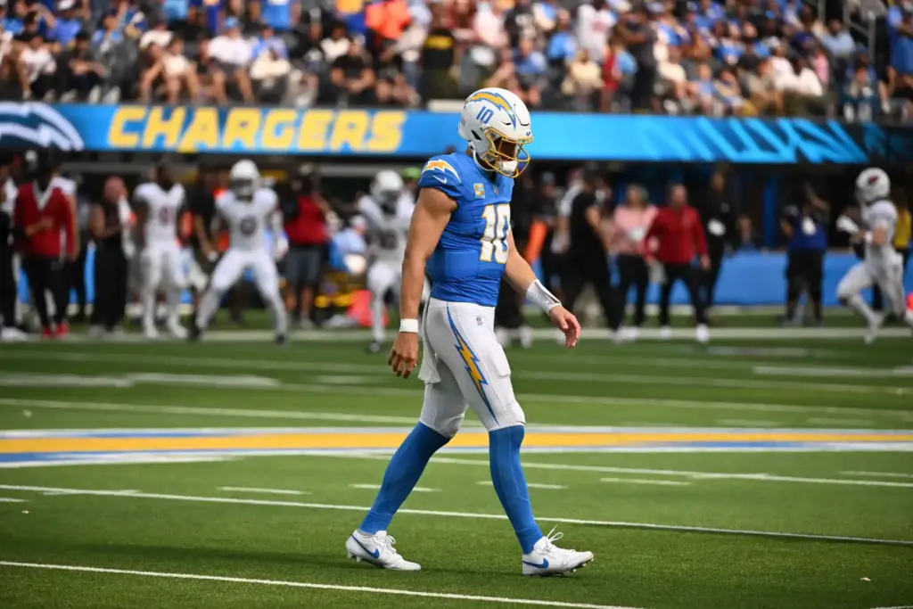 Chargers quarterback Justin Herbert (10) walks off the field after...