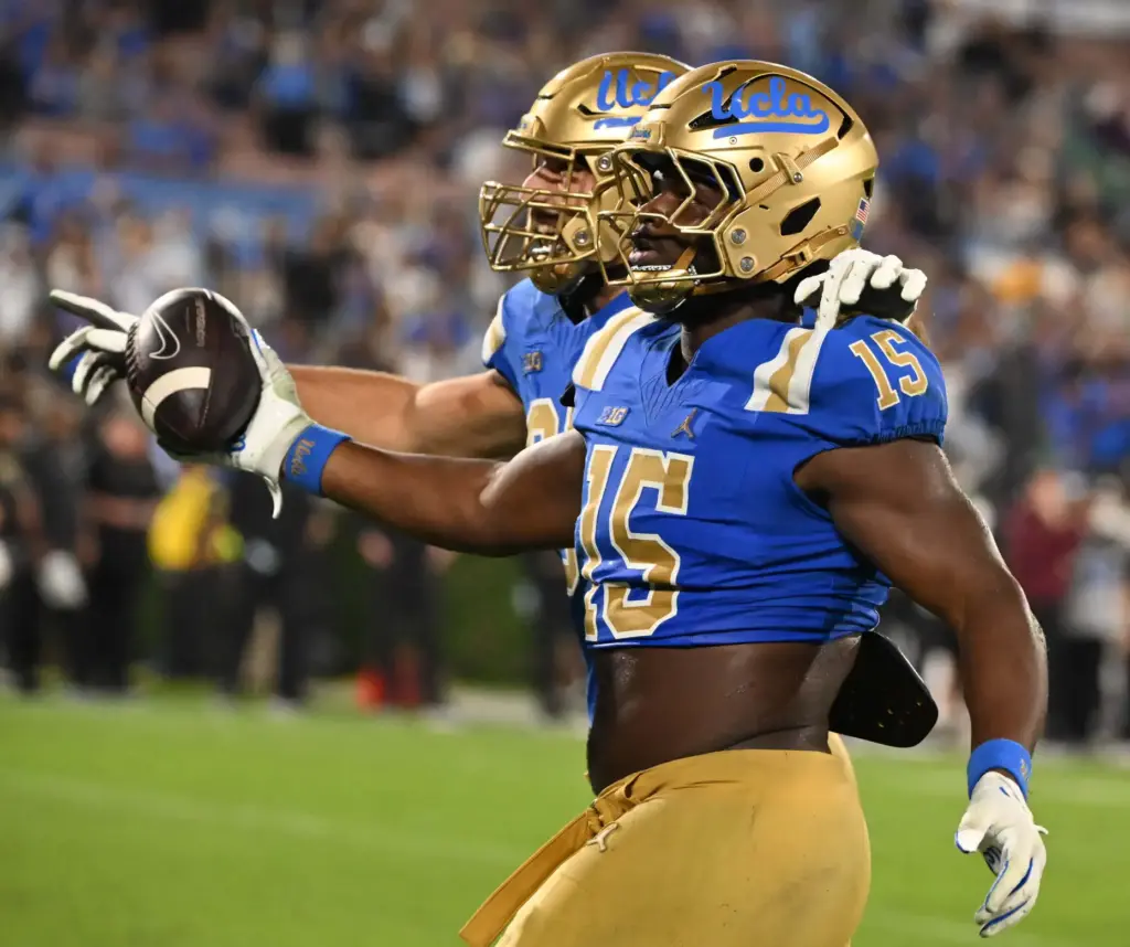 Defensive lineman Sahir West (15) of the UCLA Bruins recovers...