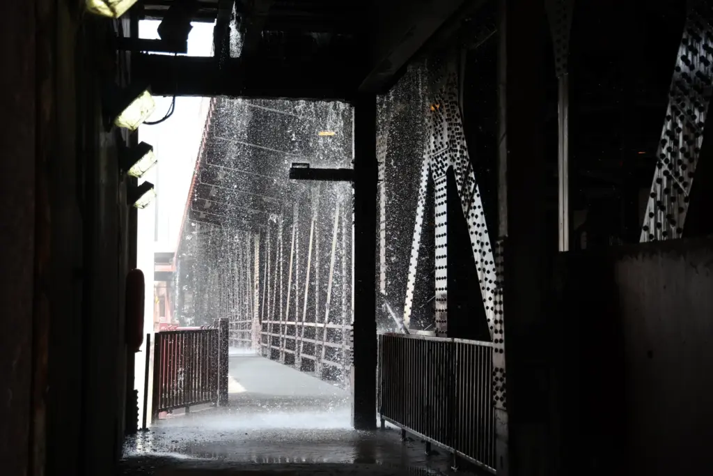 Water pumped by a Chicago Fire Department boat flows down...