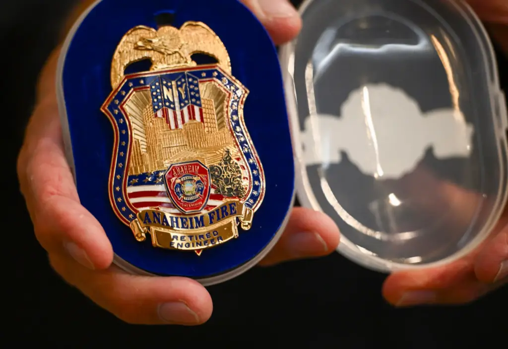Retired firefighter Fernando Negrete shows a 9/11 firefighterâs badge in...