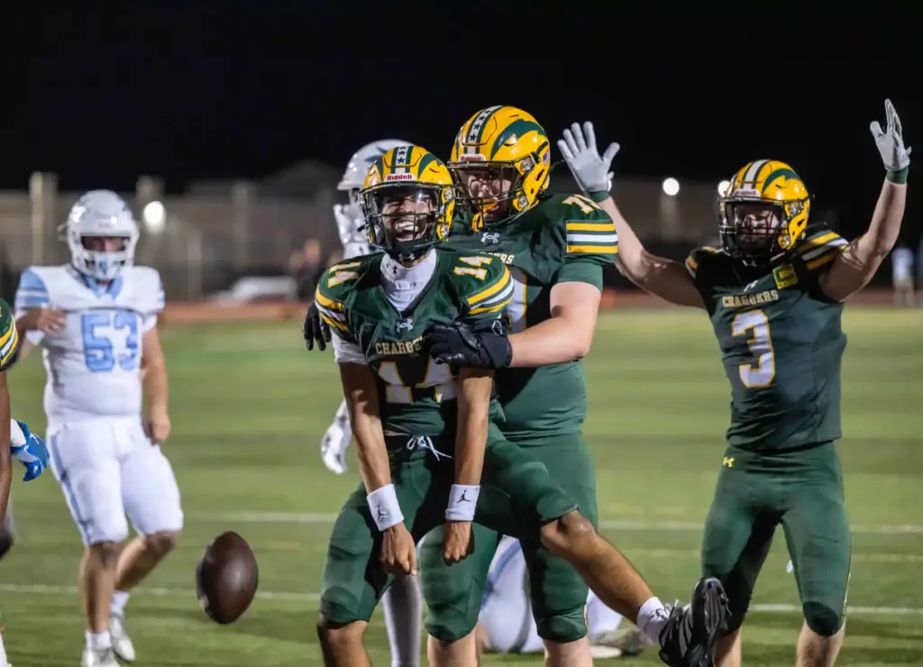 Edison players celebrate after quarterback Kellen Hairston (14) carried the...