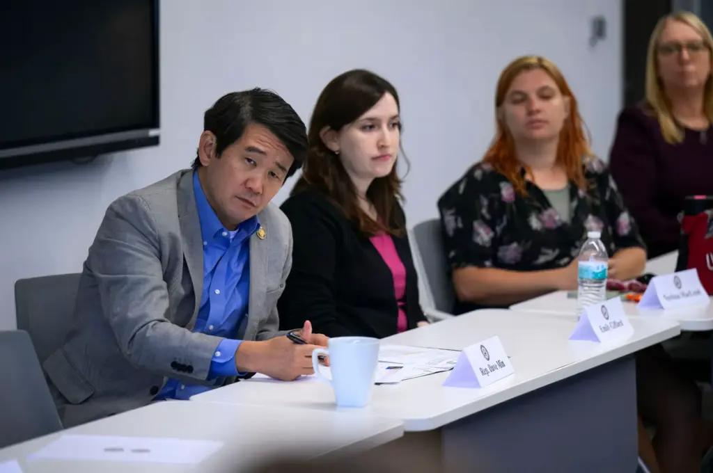 Congressman Dave Min, left, of the 47th Congressional District listens...