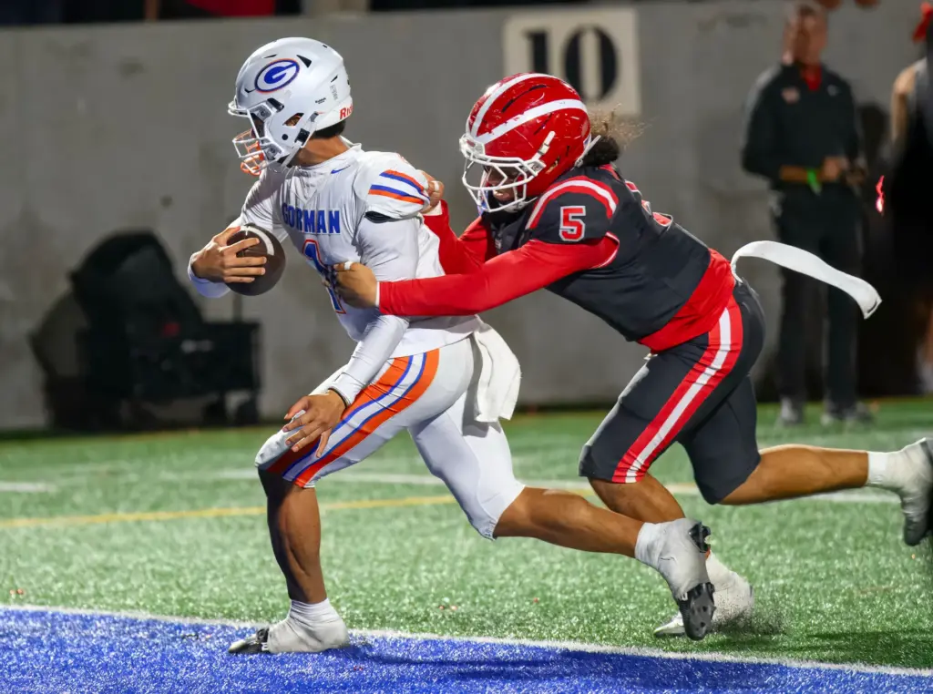 Bishop Gorman quarterback Ace Amina, left, scores a touchdown despite...