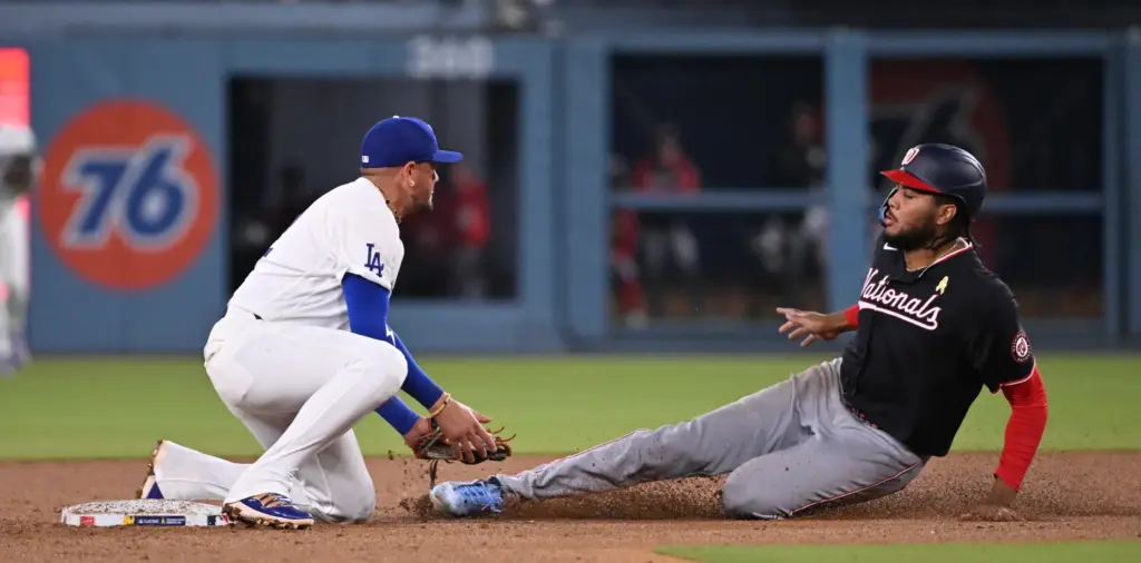 Dodgers second baseman Miguel Rojas tags out Washington Nationals outfielder...