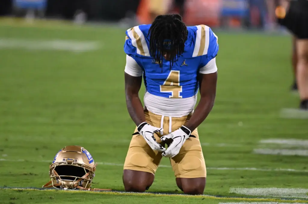 UCLA Bruins take a moment prior to a NCAA football...