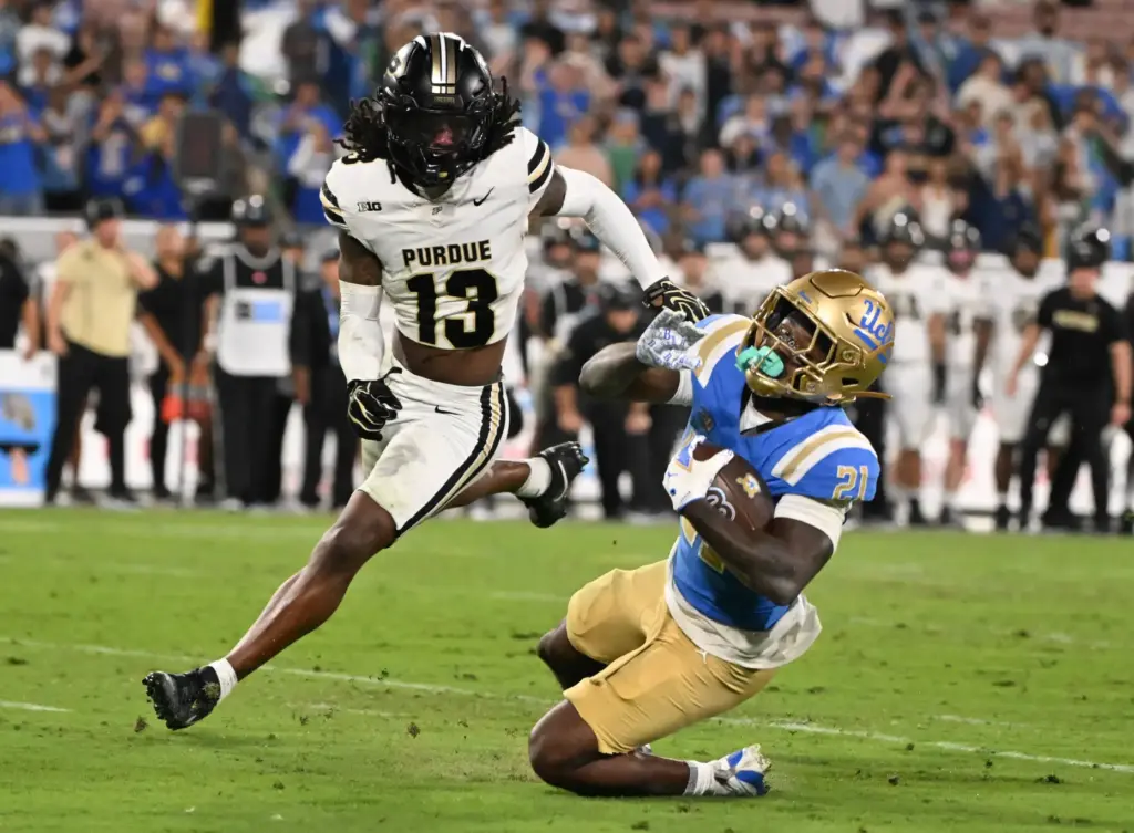Running back Jaivian Thomas (21) of the UCLA Bruins runs...