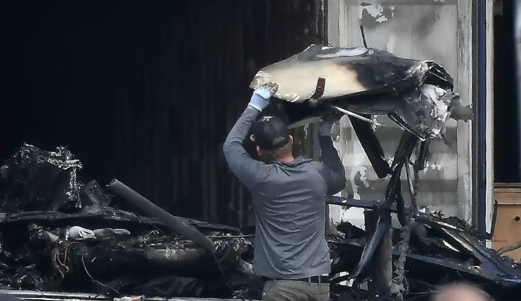 Salvage crews help NTSB investigators remove of whatâs left of...