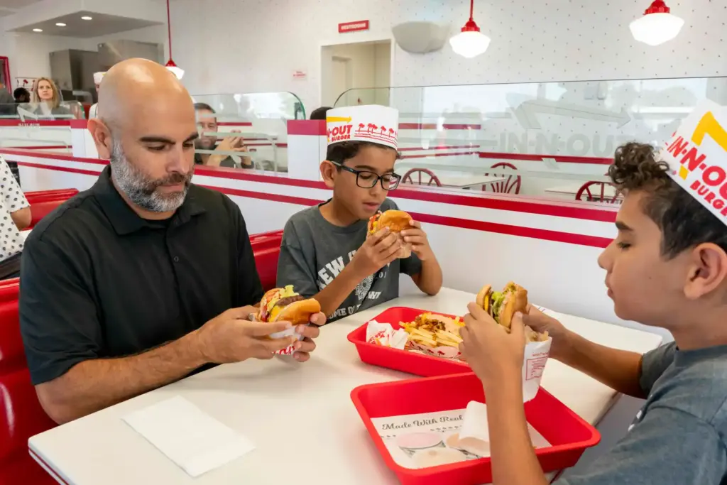 Amir Ghaneian and his sons, Adam and Zade, look at...