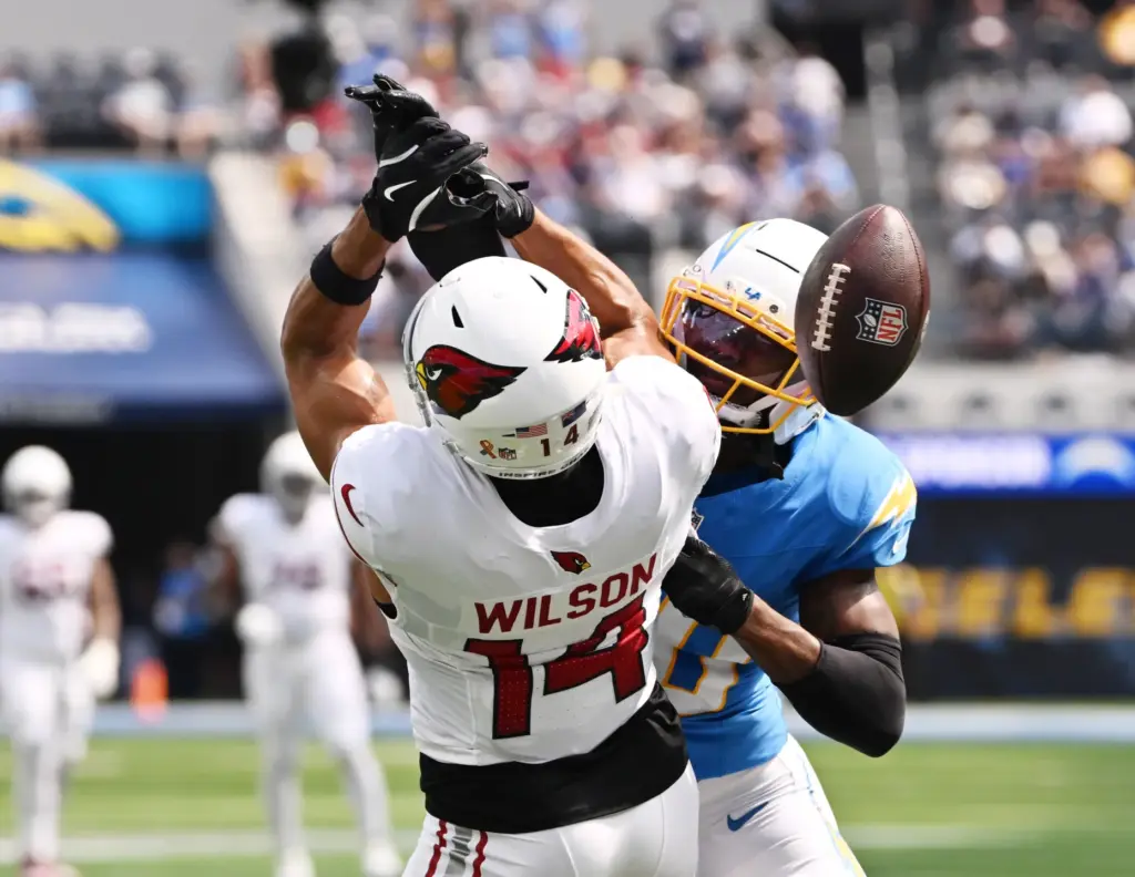 Chargers cornerback Cam Hart (20) knocks away a pass intended...
