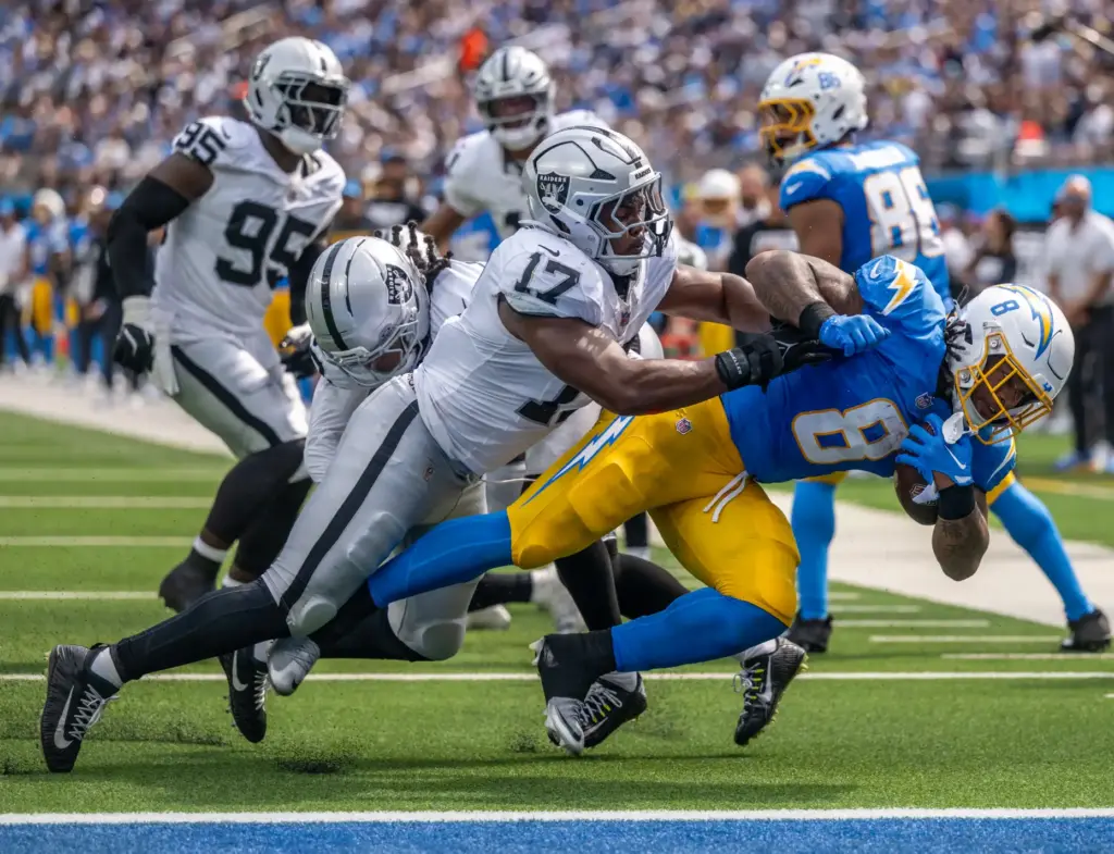 Chargers running back Omarion Hampton (8) brings the ball to...