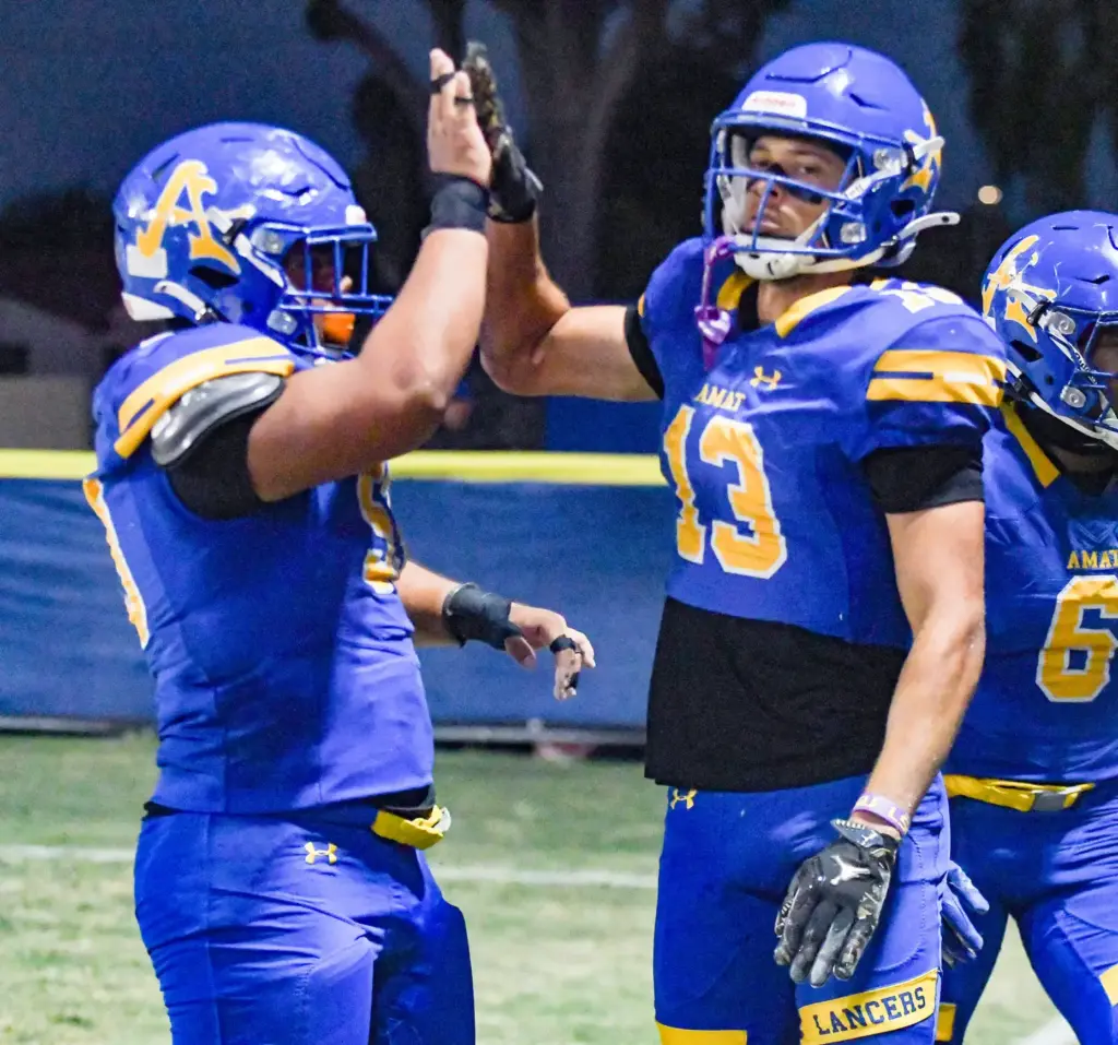 Bishop Amat receiver Jaiden Combal (13) is congratulated for scoring...