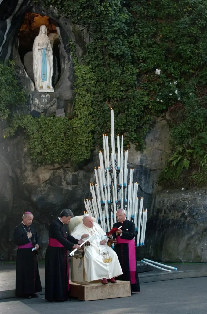 Pope John Paul II prays at the Virgin Mary shrine cave.