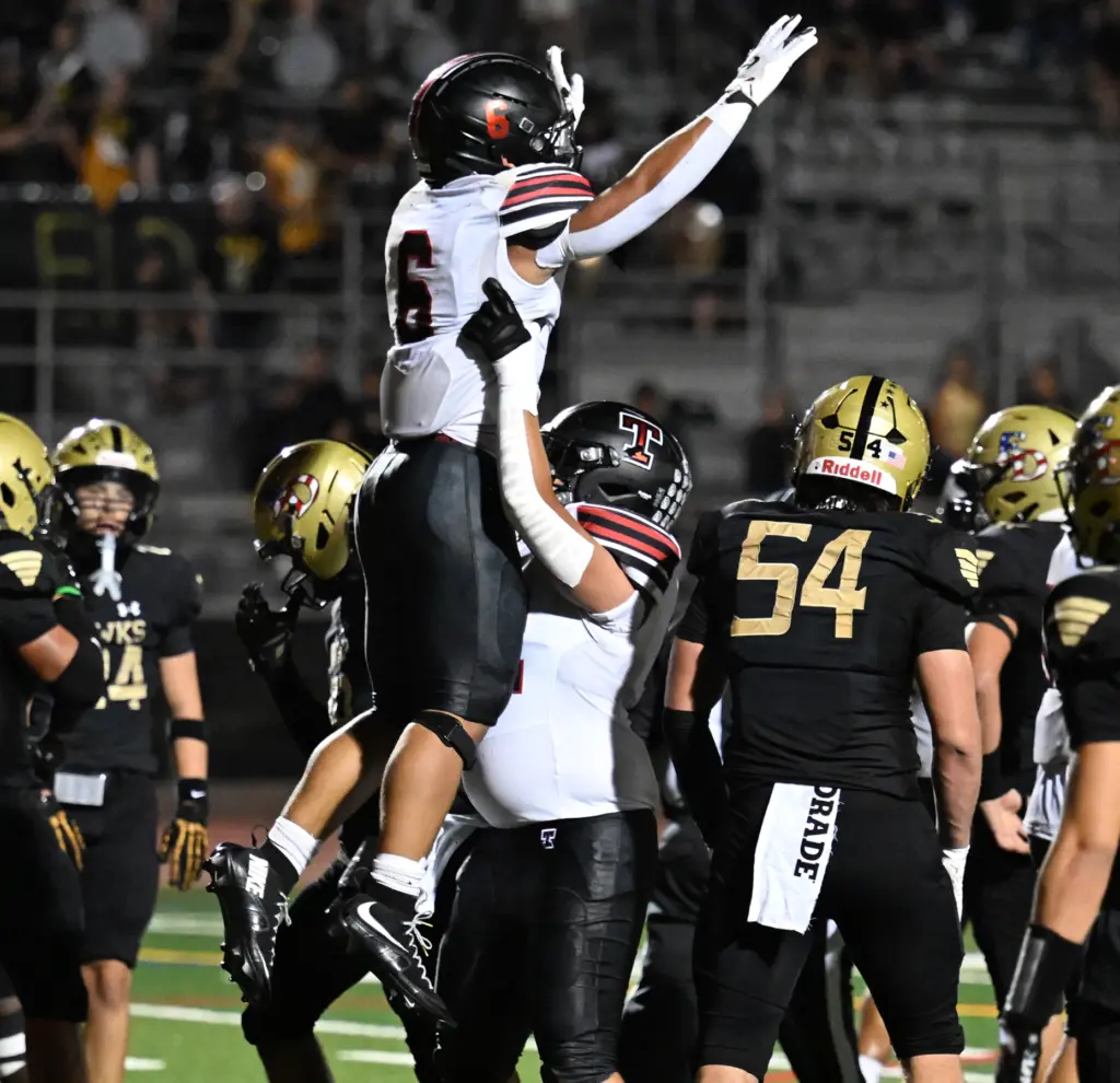 Humam al-Qaysi #52 of Troy lifts running back Riley Billington...
