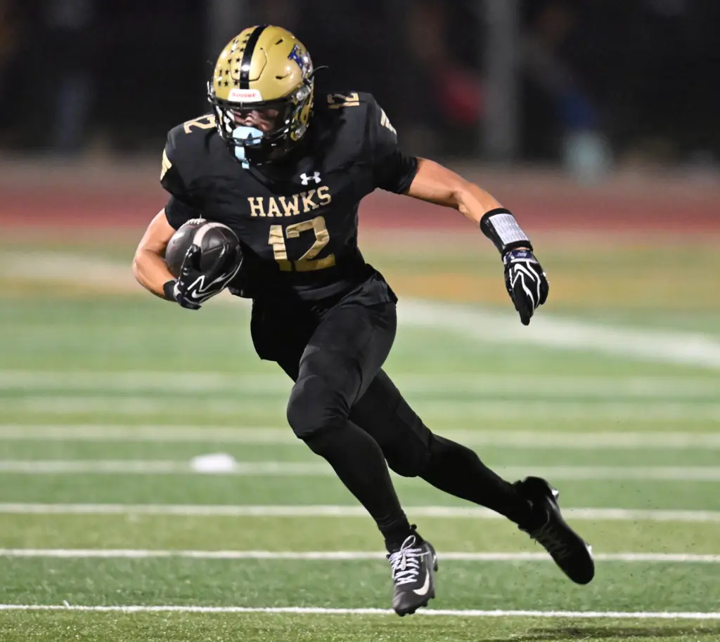 Luke Tucker #12 of El Dorado rushes in the first...