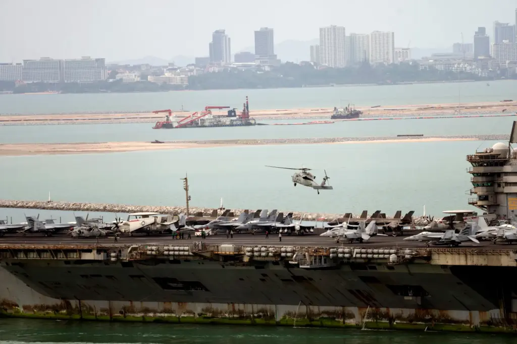 A helicopter lands on the U.S. Navy aircraft carrier USS Abraham Lincoln.