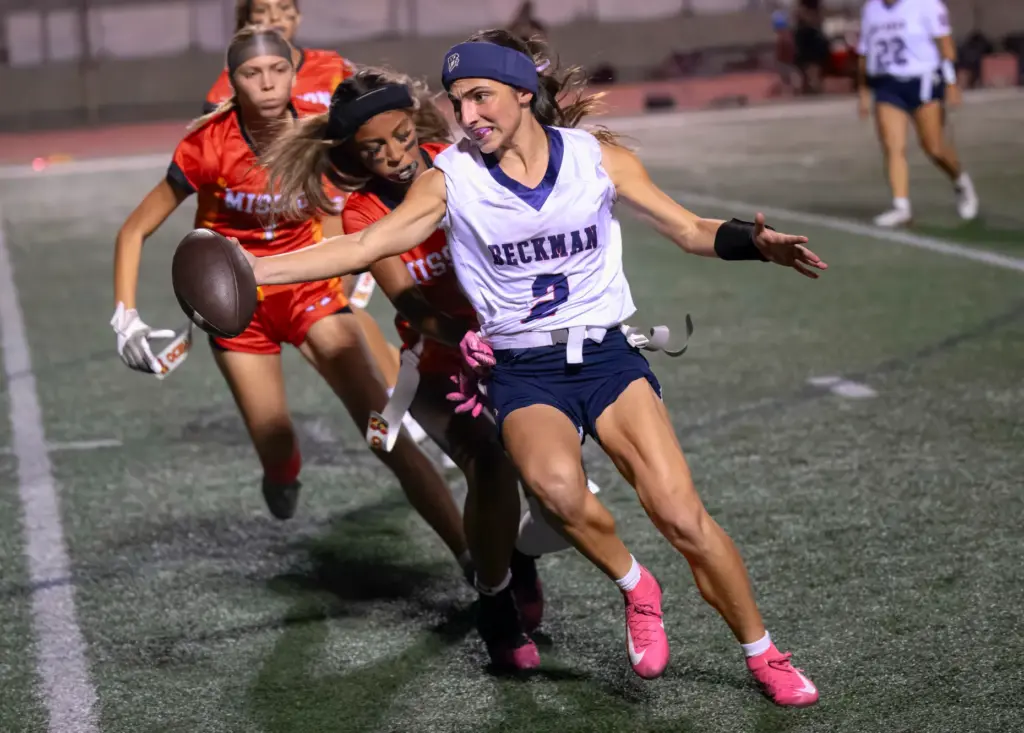 Beckman quarterback Marina Babayani stretches for a first down against...