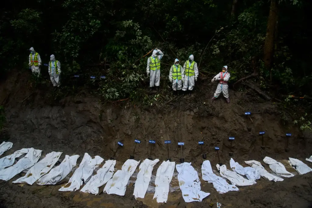 Nepal police personnel prepare the bodies of flash flood victims for a mass burial.