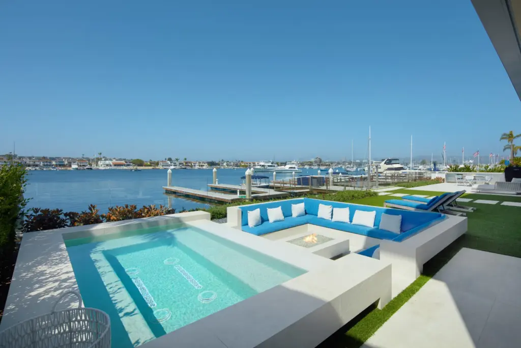 The bayfront terrace features a sunken seating area around an...