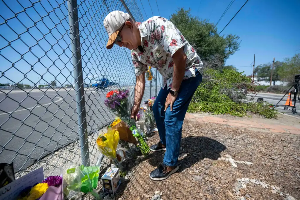 Pilot Frank Bagheri places flowers at a memorial for NBCLA...