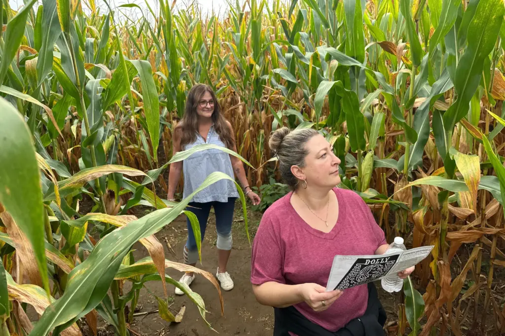Jaime Wanzer, holding a map, and Wendy Mayerson navigate a...