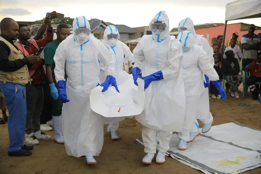 Ebola response teams organize a public demonstration to raise awareness...
