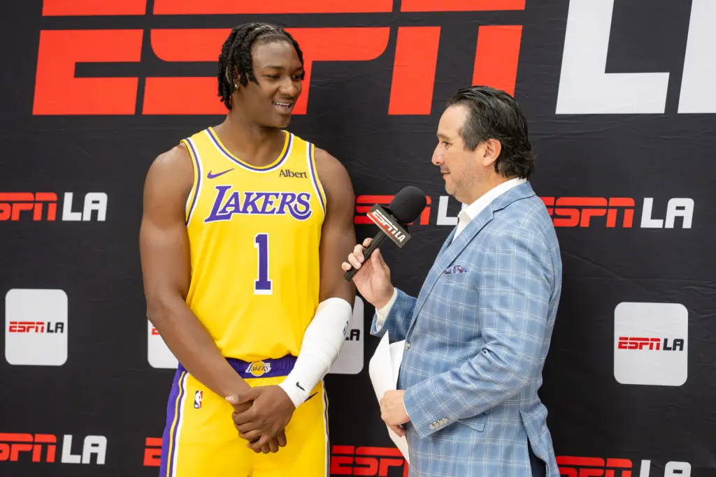 Lakers forward Adou Thiero does an interview listens to questions...