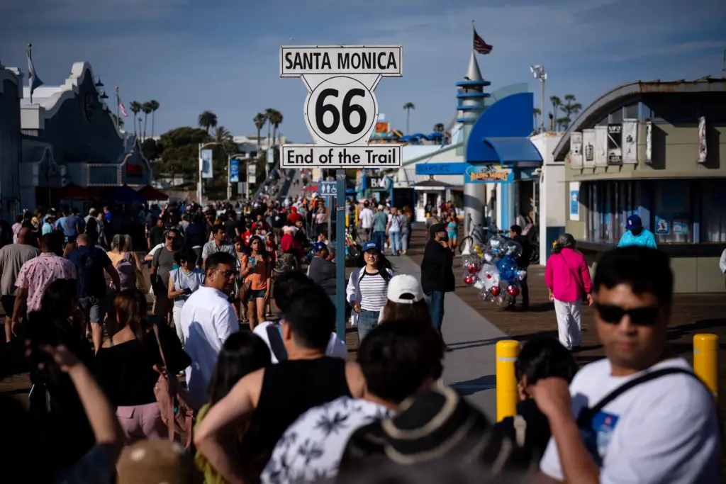 Visitors pose for pictures at the Santa Monica Pier, where...