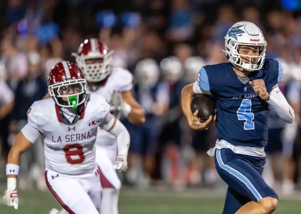 Corona del Mar quarterback John David Annett (4) carries the...