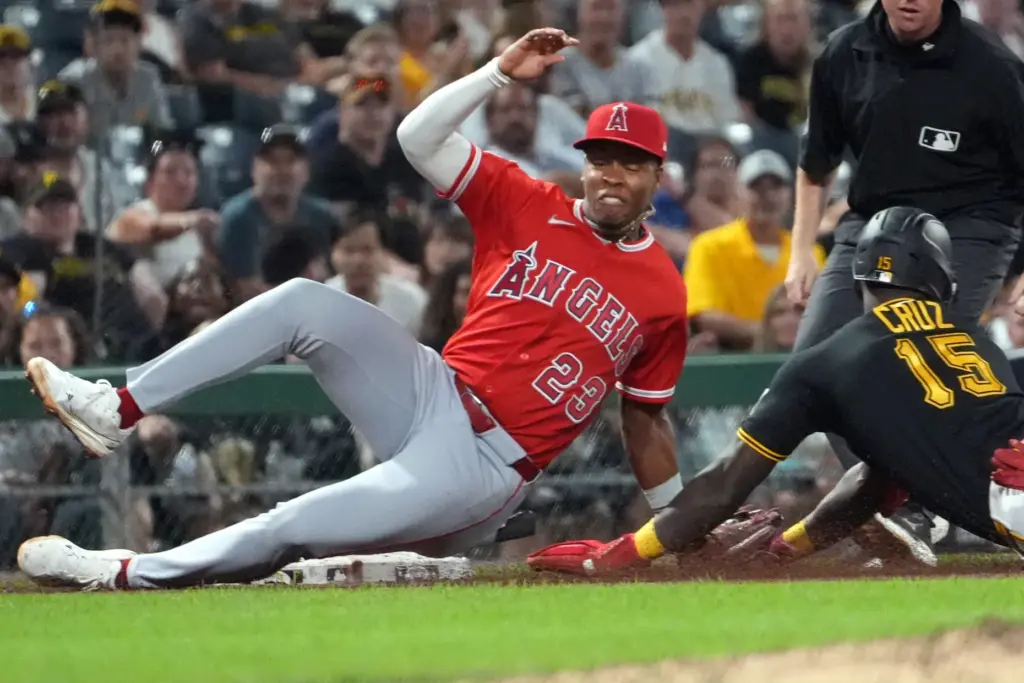 Angels third baseman Denzer Guzman (23) tags out Pittsburgh Pirates’...