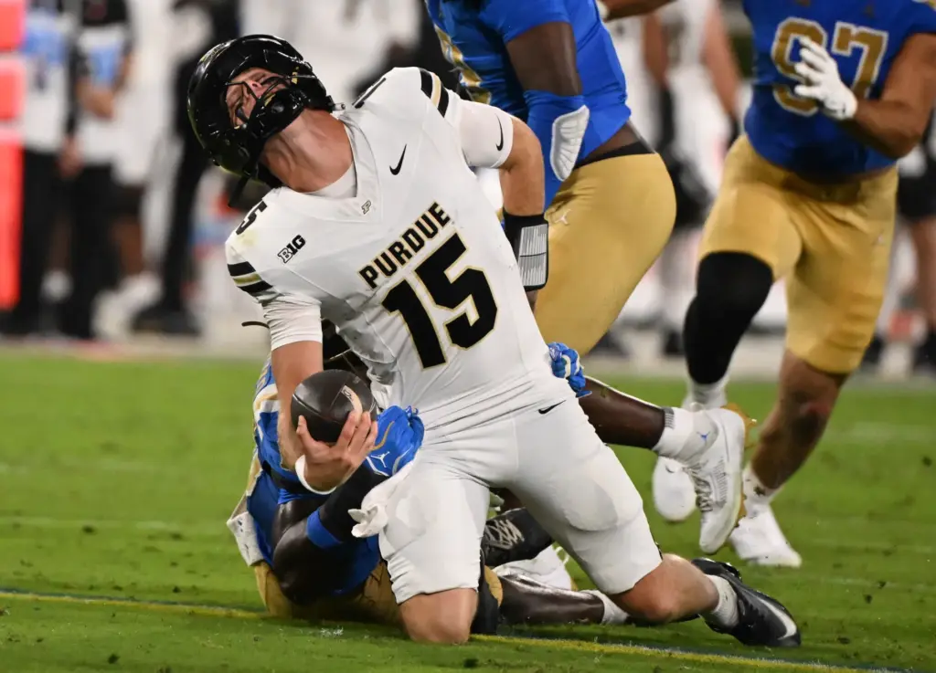 Linebacker Sammy Omosigho (10) of the UCLA Bruins sacks quarterback...