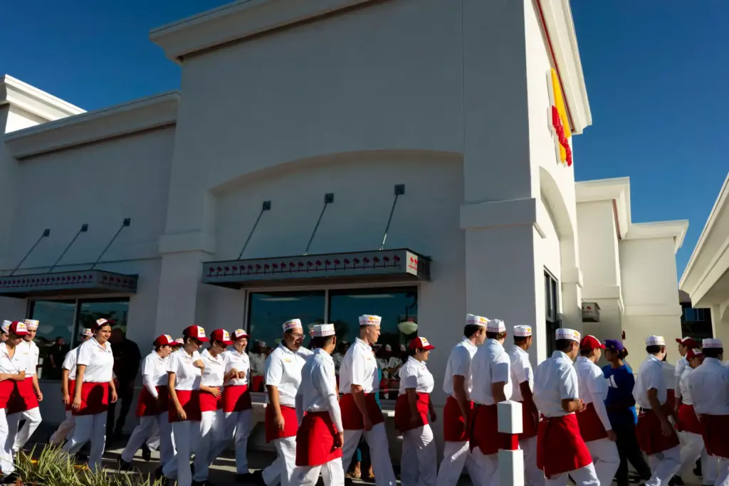 Employees of In-N-Out Burger enter through the side door of...