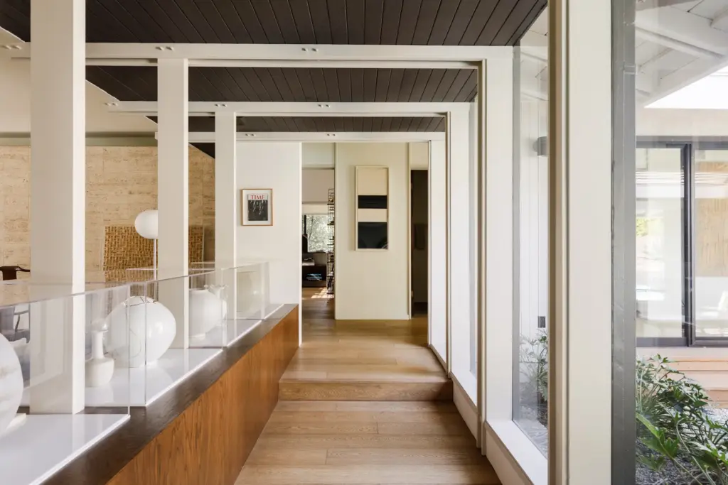 A glass breezeway connects the main living area to the...