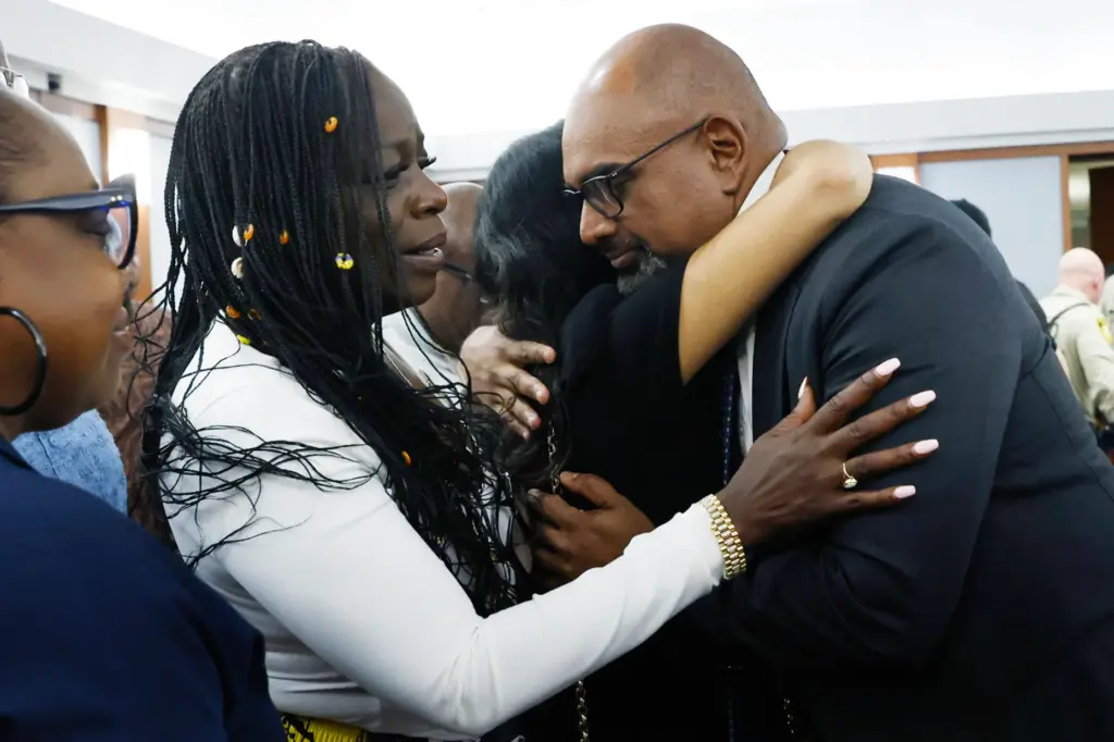 Friends and family members of rapper Tupac Shakur line up to hug Chief Deputy District Attorney Binu Palal.