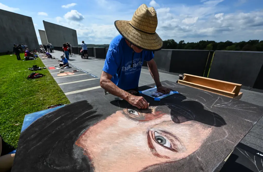 Chalk artist Graham Curtis draws Alan Anthony Beaven, a passenger...