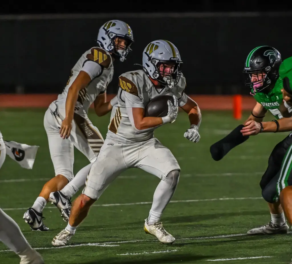 West Torrance running back Jack MacInnis runs with the ball...