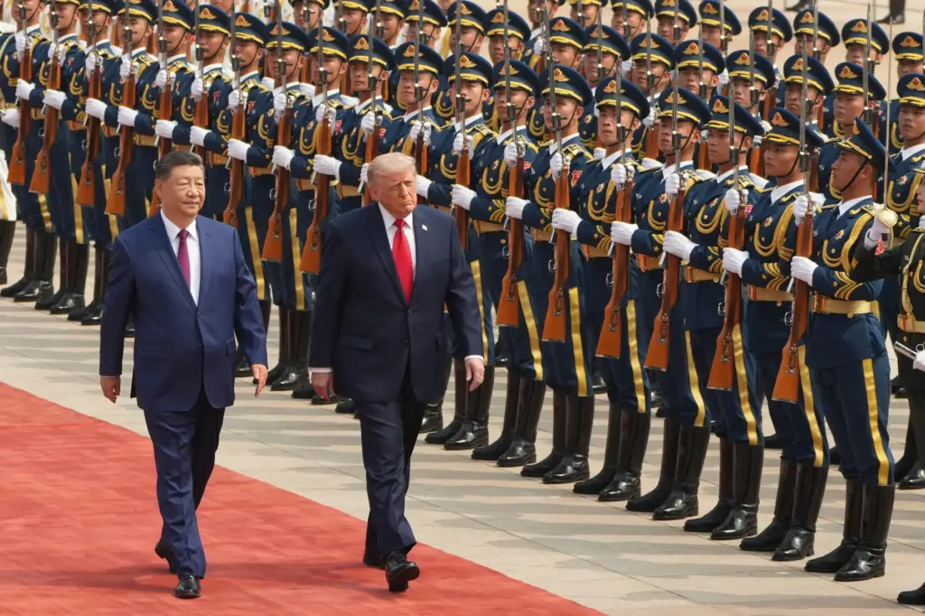 FILE – President Donald Trump, right, participates in a welcome...