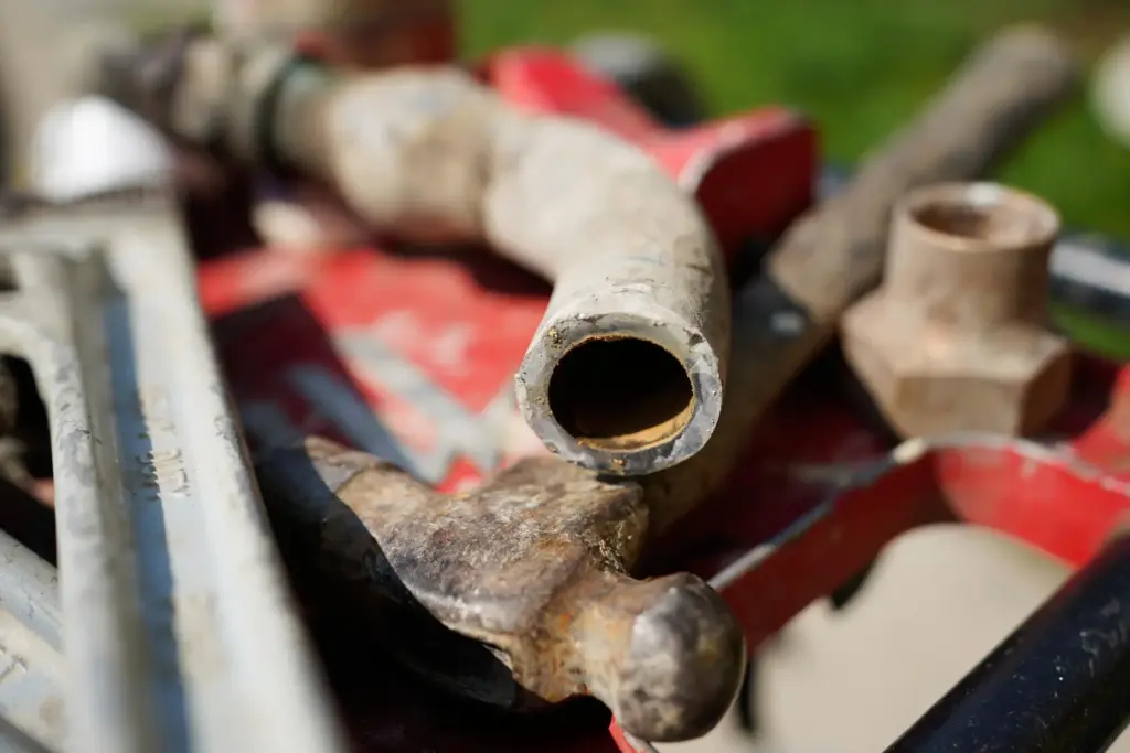 A lead pipe that brought drinking water to homes sits...