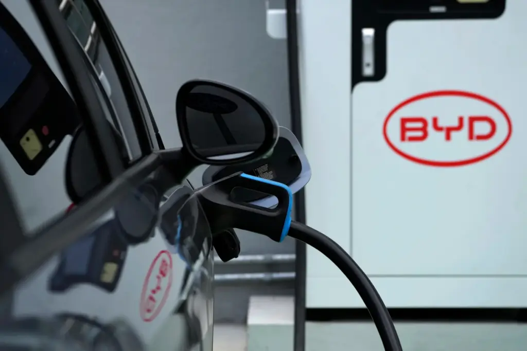 FILE – A BYD electric vehicle charges at a dealership...
