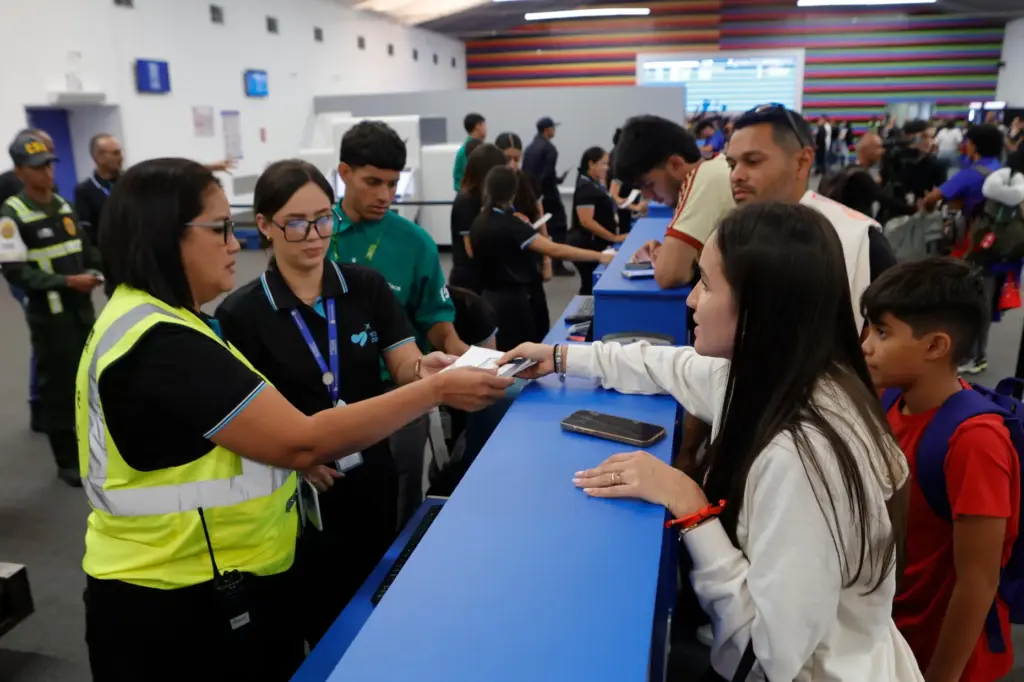 Passengers check in at Simon Bolivar International Airport as it...