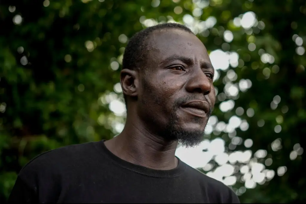 Harounat Sarre, a Mauritanian immigrant, pauses in the parking lot...