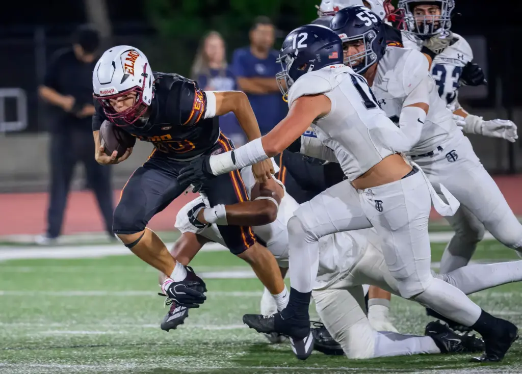 El Modena’s Ethan Sorenson picks up some yardage against the...