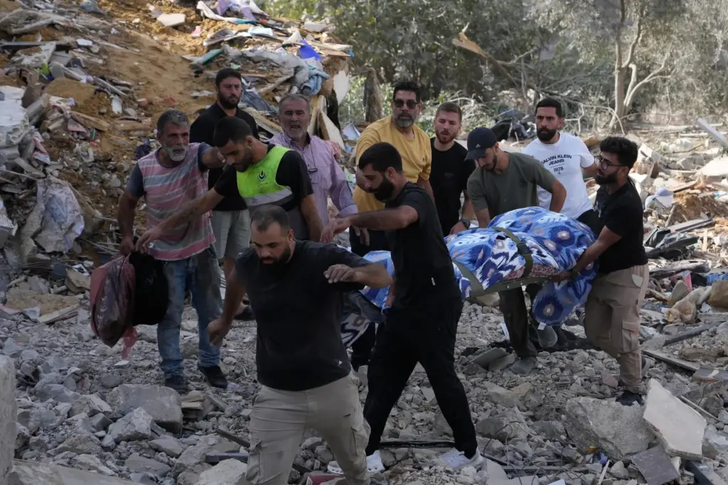 People carry a body of a person who was killed...